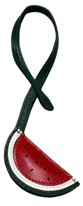 A watermelon slice shaped leather bag charm with a dark green strap, featuring red, white, and black details on a plain white background.